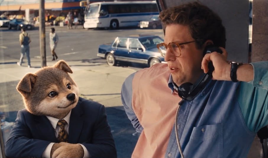 The colleague on a payphone with the Wolf mascot waiting beside him